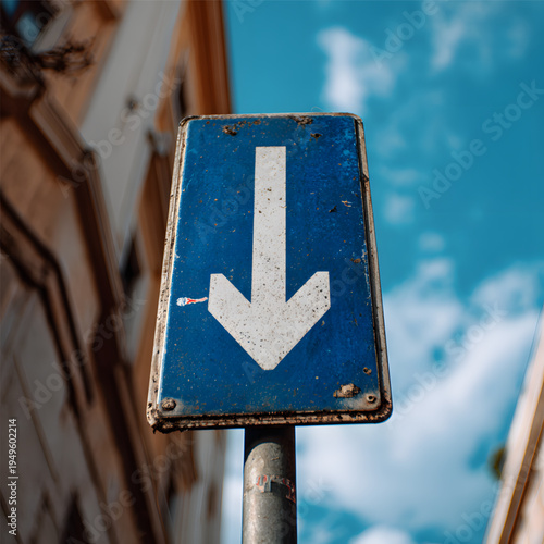 Blue traffic sign with white arrow.