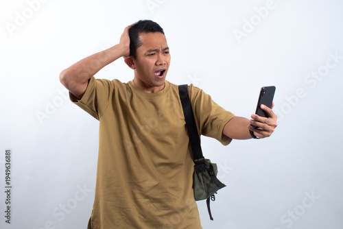 Man using smartphone, looking shocked.
