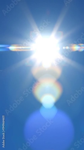 Bright sun with lens flare in a clear blue sky