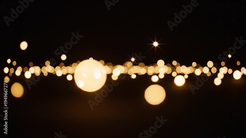 Glowing lights streak across a dark background with bokeh effect in a mesmerizing display of illumination.
