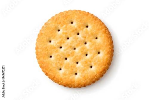 Round cracker biscuit, single golden baked snack with small holes, isolated shot
