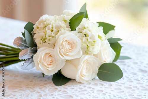 Bridal bouquet featuring white roses and hydrangeas on lace