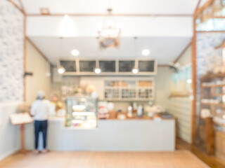 Blurred cafe and bakery interior background with warm lighting and clean modern design, creating soft bokeh atmosphere ideal for coffee shop promotion, lifestyle branding, and cozy workspace concept.