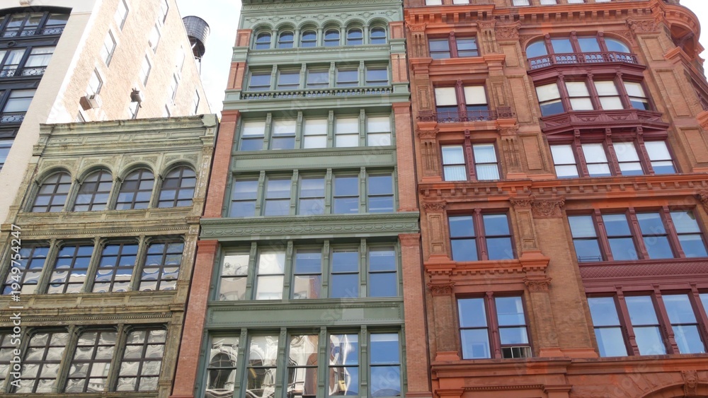 Fototapeta premium New York City urban buildings architecture, Manhattan Broadway street United States of America. Red brick classic house, USA. Typical old historic real estate property in NYC.