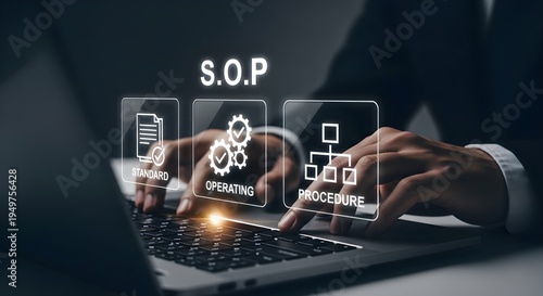 Close-up of a businessman's hands typing on a laptop with operating process icons floating above the keyboard in a dark room.