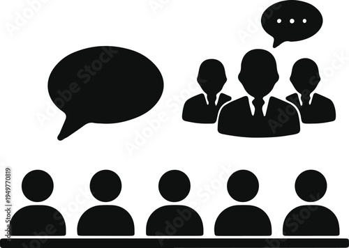 A group of people listening to a speaker with a few individuals engaging in discussion.