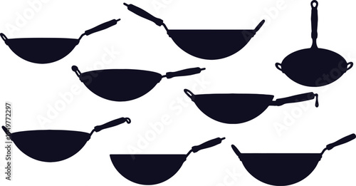 Assorted woks and frying pans displayed in a stylized arrangement