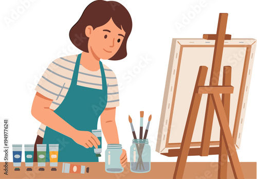 A woman paints on an easel with brushes and tubes of paint nearby indoors.