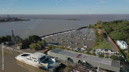 Exploring a marina and river near a city with boats and greenery