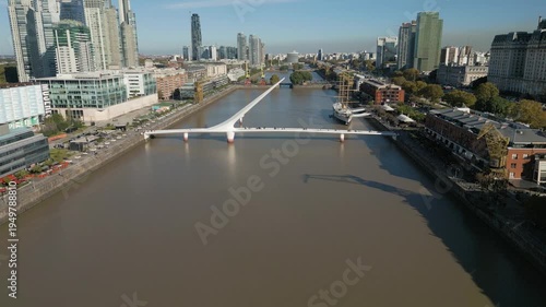 View of bridge crossing river in Buenos Aires with city skyline in background