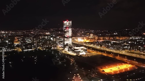 Wallpaper Mural Aerial nighttime view of Budapest featuring the illuminated Mol Tower, vibrant city lights, surrounding urban landscape, and visible traffic in Hungary's bustling capital. Torontodigital.ca