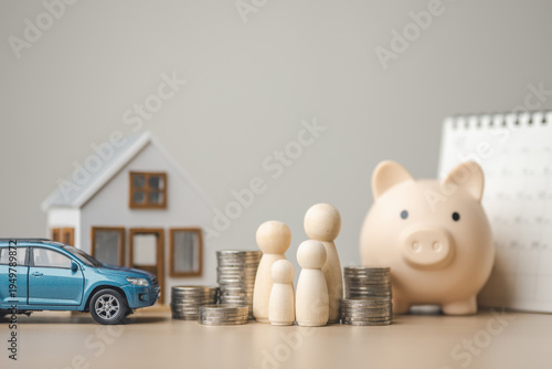 Fotografía Family financial planning concept with house model, car, piggy bank and stacked coins