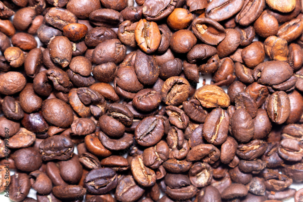 Fototapeta premium Aromatic roasted coffee beans pile texture background for delicious beverage and energy drink concept