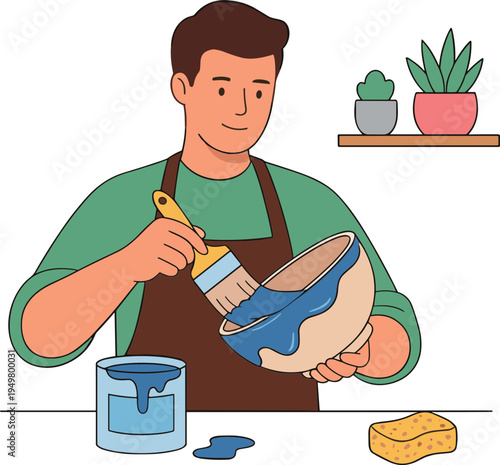 A man is painting a bowl blue with a brush indoors.