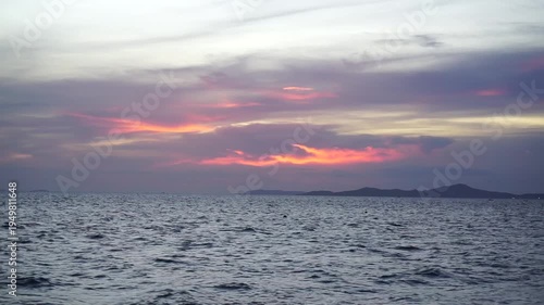 Sunset light reflection on clouds with silhouette of island, Thailand