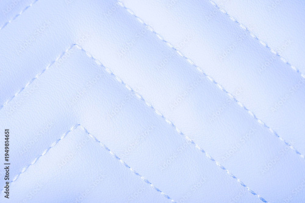 Naklejka premium Detailed close up of soft light blue quilted textile material surface showing elegant chevron stitching