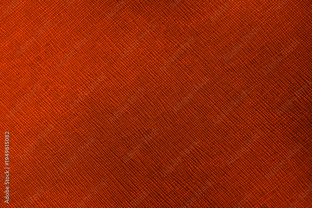 Fototapeta premium Close up abstract textured rustic burnt orange fabric background with diagonal woven pattern