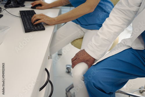 фотографія Inappropriate behavior of doctor, holding nurse by thigh