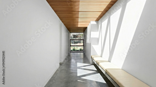 Modern architectural corridor with wooden ceiling, concrete floor, and large windows allowing natural light to illuminate the minimalist design and seating area