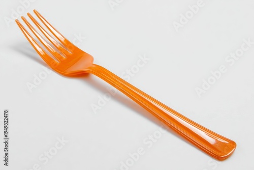 Disposable orange plastic dinner fork.