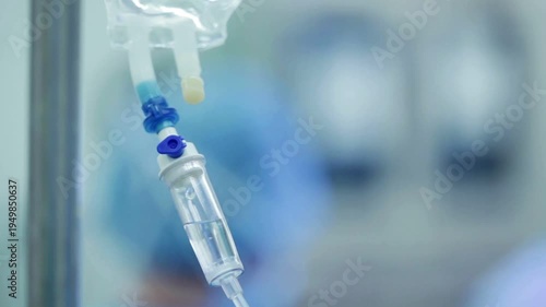 vitamin IV drip chamber dripping in slow motion Closeup view of IV drip in hospital medical and closeup of worker with bag for wellness Slow motion