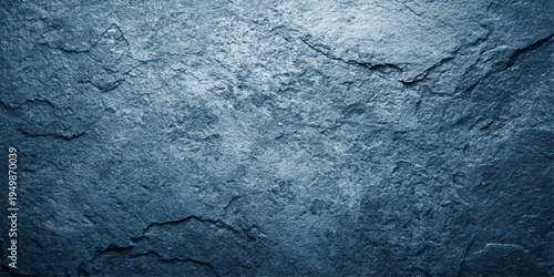 A rough blue grunge texture with a dirty paint pattern on an old concrete wall surface creates a weathered stone and marble backdrop design