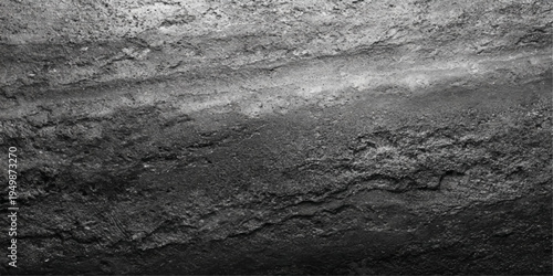 An abstract black and white landscape captures the textured pattern of an old stone wall blending into a natural background of rocks and sand