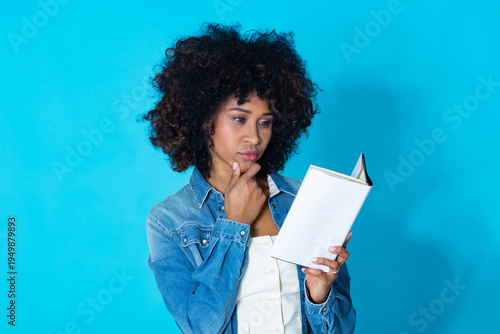 young latina woman with textbook isolated on background