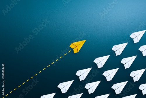 Group of white paper plane in one direction and one yellow paper plane pointing in different way. Business for innovative solution concept.