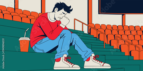 A man in a red shirt and blue jeans sits on green stadium stairs with orange seating and a screen in the background.