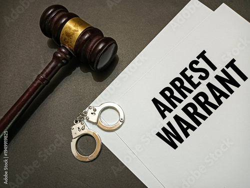 Fotografie Arrest warrant document with judge gavel and handcuffs on desk representing legal authority, criminal justice system, police enforcement, investigation, and law order concept