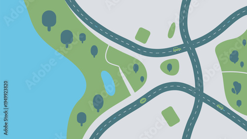 An aerial view of a park with winding roads and green spaces near a body of water