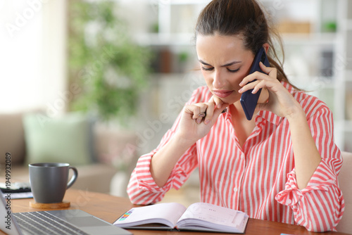 Disgusted self employed checking agenda talking on phone