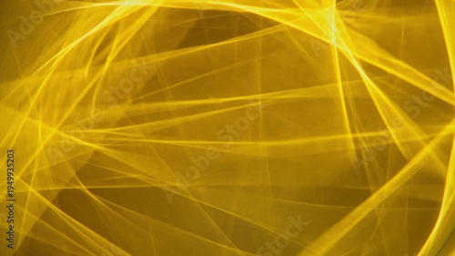 Abstract golden light lines creating a vibrant pattern and texture, forming an energetic glowing background suitable for technology, celebration, or futuristic concepts