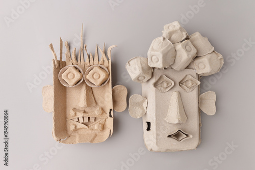 Funny faces made from recycled egg cartons for kids diy craft project. Creative paper pulp masks for school art lesson, sustainable hobby, home activity, eco friendly toy design