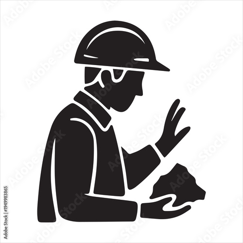 Silhouette of a worker in hard hat holding rock sample geology