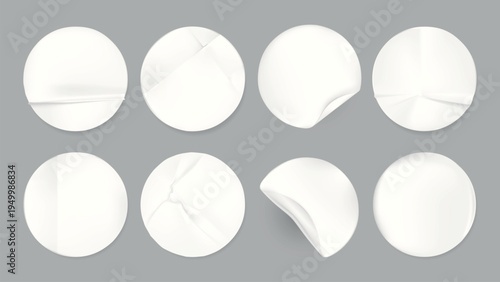 Set of eight white round stickers on a gray background. Each sticker has a unique fold or curl. Perfect for design, decoration, or labeling projects. Sticker element vector set.