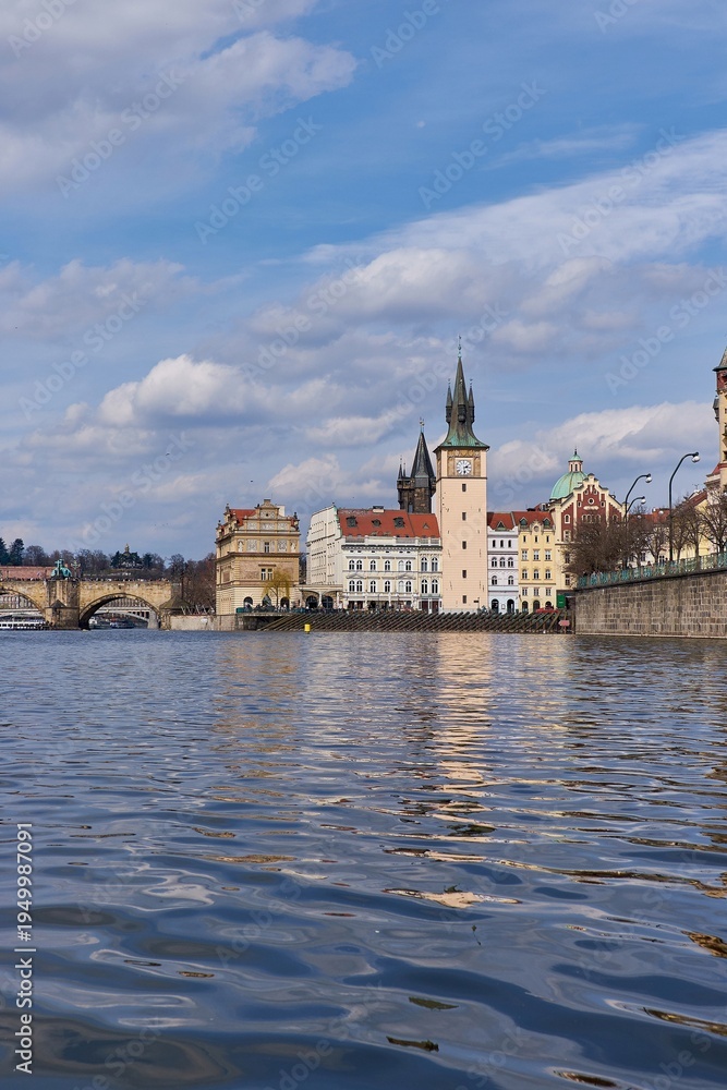 Fototapeta premium Vltava River flowing beside historic Old Town with Charles Bridge in Prague