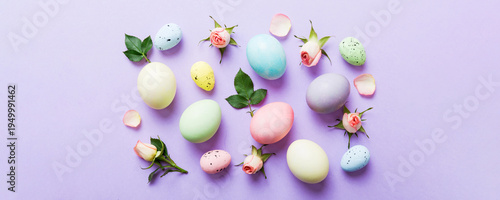 Wallpaper Mural Happy Easter. Easter eggs on colored table with yellow roses. Natural dyed colorful eggs background top view with copy space Torontodigital.ca