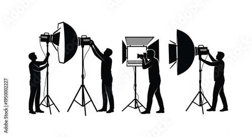 Silhouettes of professional photographers and assistants working with studio lighting equipment