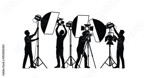 Silhouettes of professional photographers and videographers working with studio lighting equipment