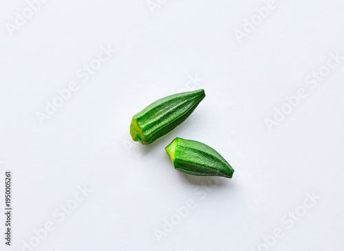 two okra pods on a gray background
