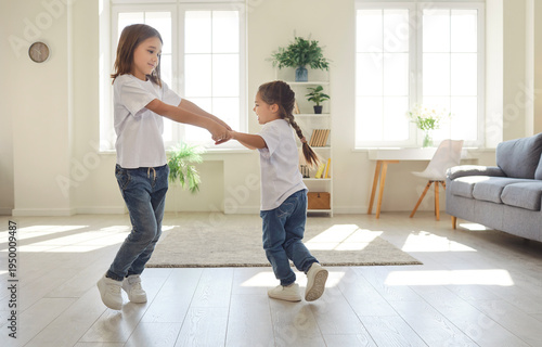 Fotografi Happy children playing at home, little siblings brother and sister have fun toge