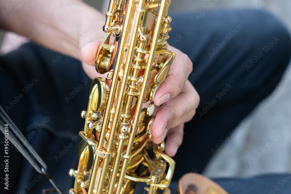 Naklejka premium Authentic Musician Playing Golden Saxophone Instrument Outdoors on a Rustic Bench