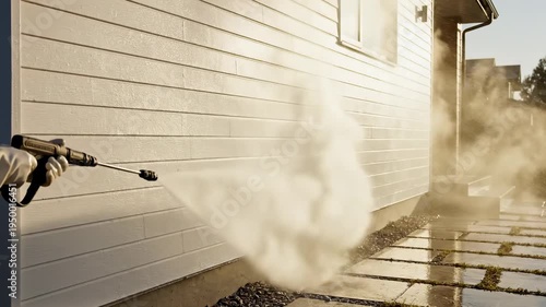Exterior Surface Power Cleaning concept inspired by professional pressure washing service, wide-angle view of a modern house facade with sections of siding transitioning from dull gray to bright