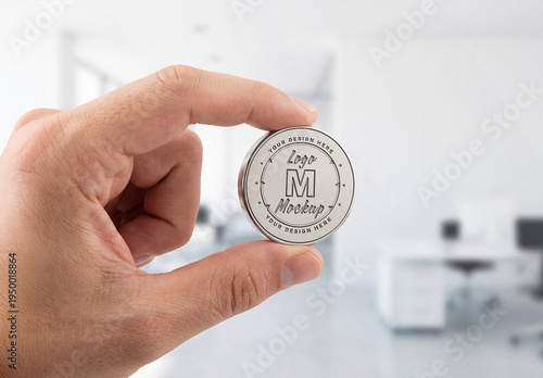 Man’s Hand Holding Cicular Silver Coin Logo Mockup