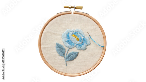 Cuadro en lienzo Isolated handcrafted blue flower embroidery art in a wooden hoop with needle and