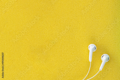 Minimalist Headphones on Vibrant Yellow Background with Copy Space
