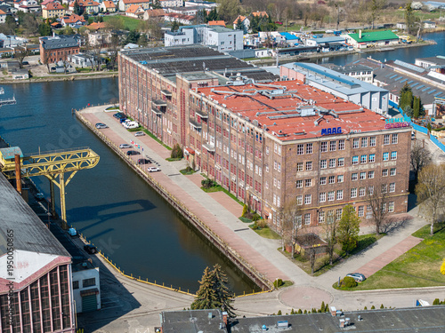 Obraz na plátně Brick post-industrial building near canal in Elbląg converted into office space