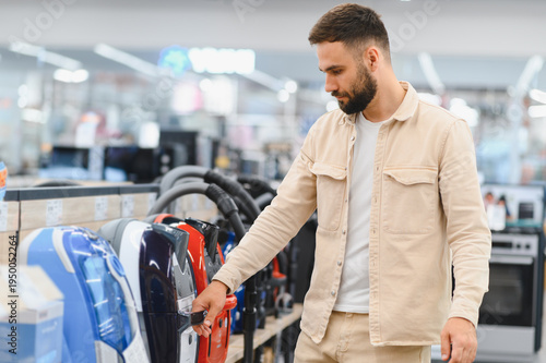 Obraz na płótnie Customer choosing vacuum cleaner in electronics store